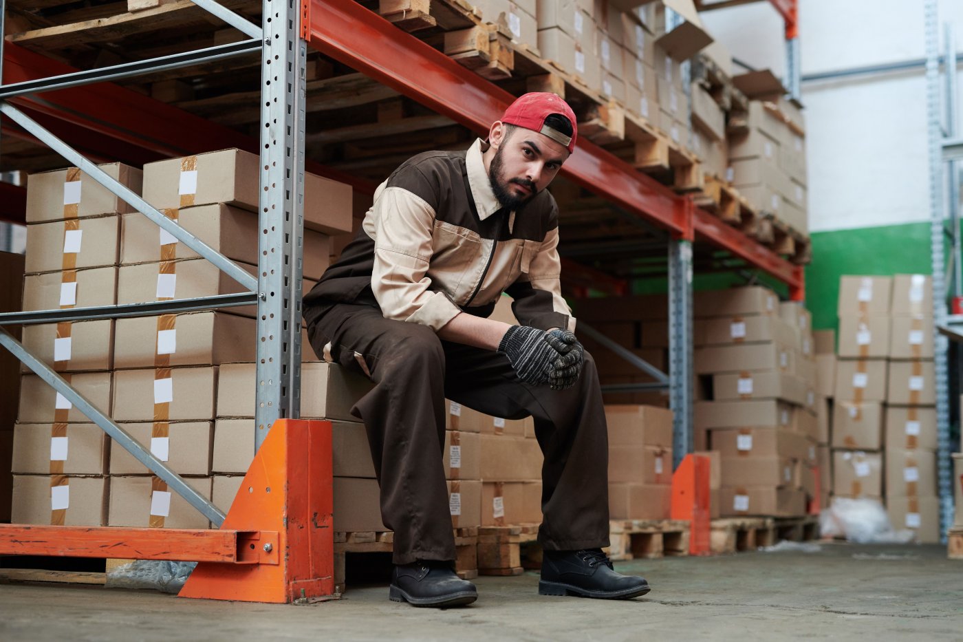 A warehouse worker checking delivered stock against a goods received note