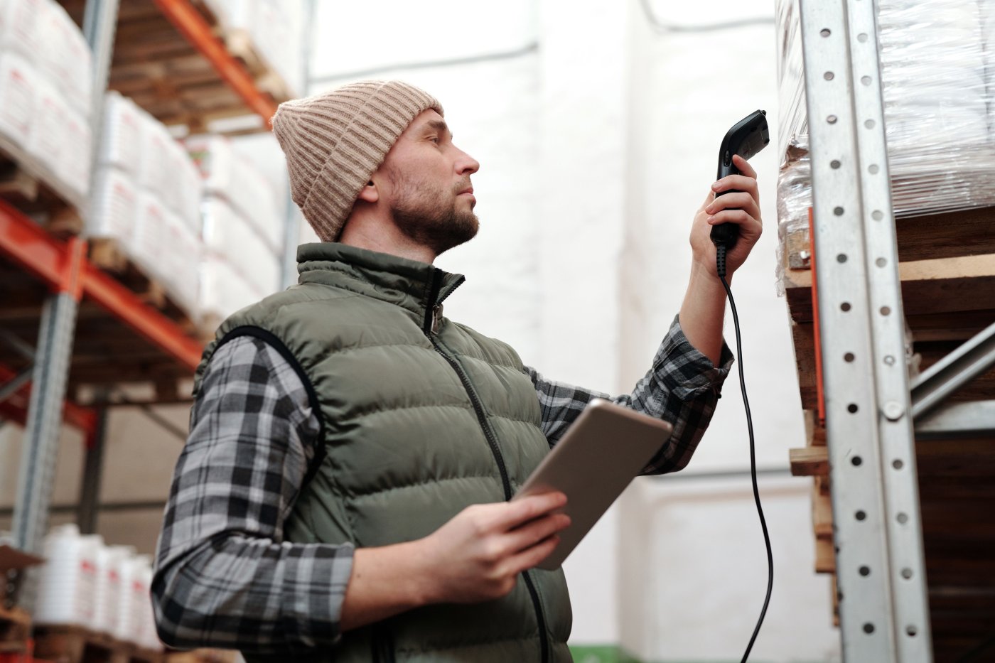 A warehouse worker scanning received stock against a purchase order